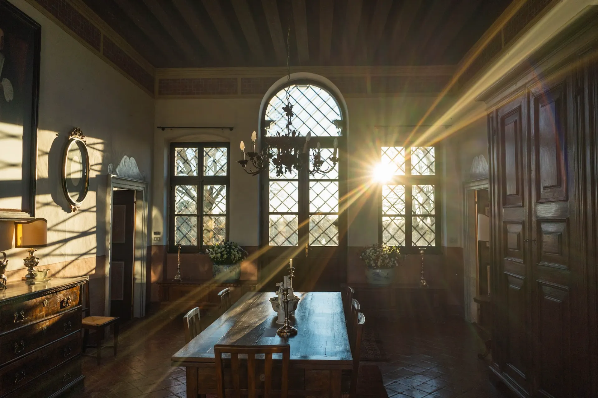 Elegant noble dining room of Villa Ottelio de Carvalho with historic wooden table and natural light