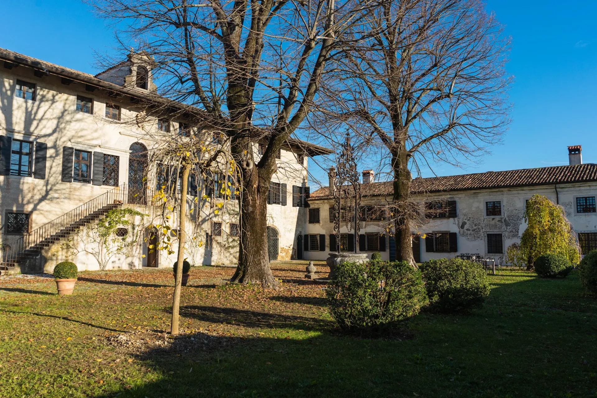 Winter view of Villa Ottelio de Carvalho with ancient trees and monumental garden